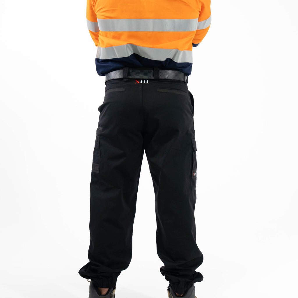 Person wearing an orange high-visibility jacket and black pants on a white background