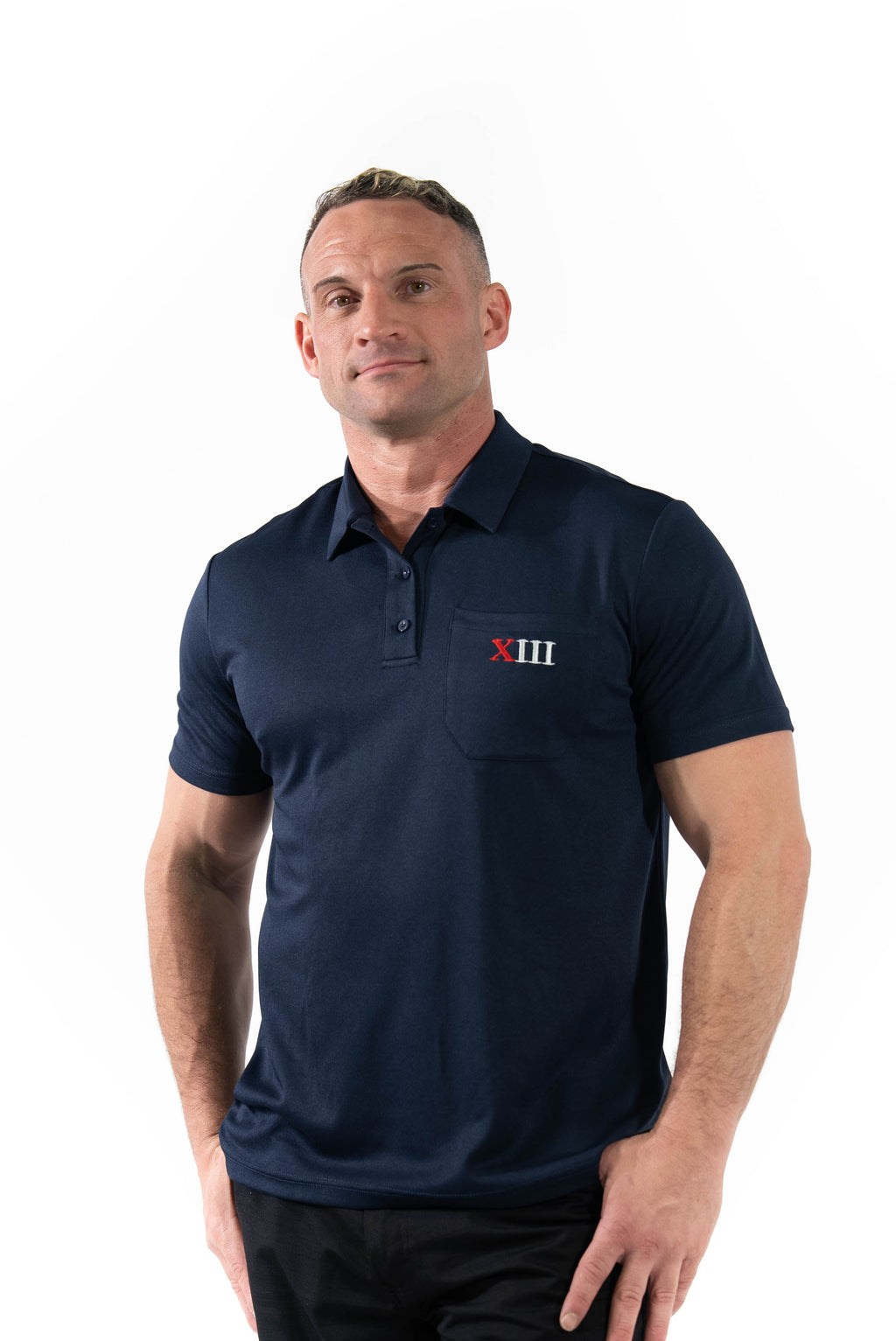 Man wearing a navy blue polo shirt with a logo on a white background