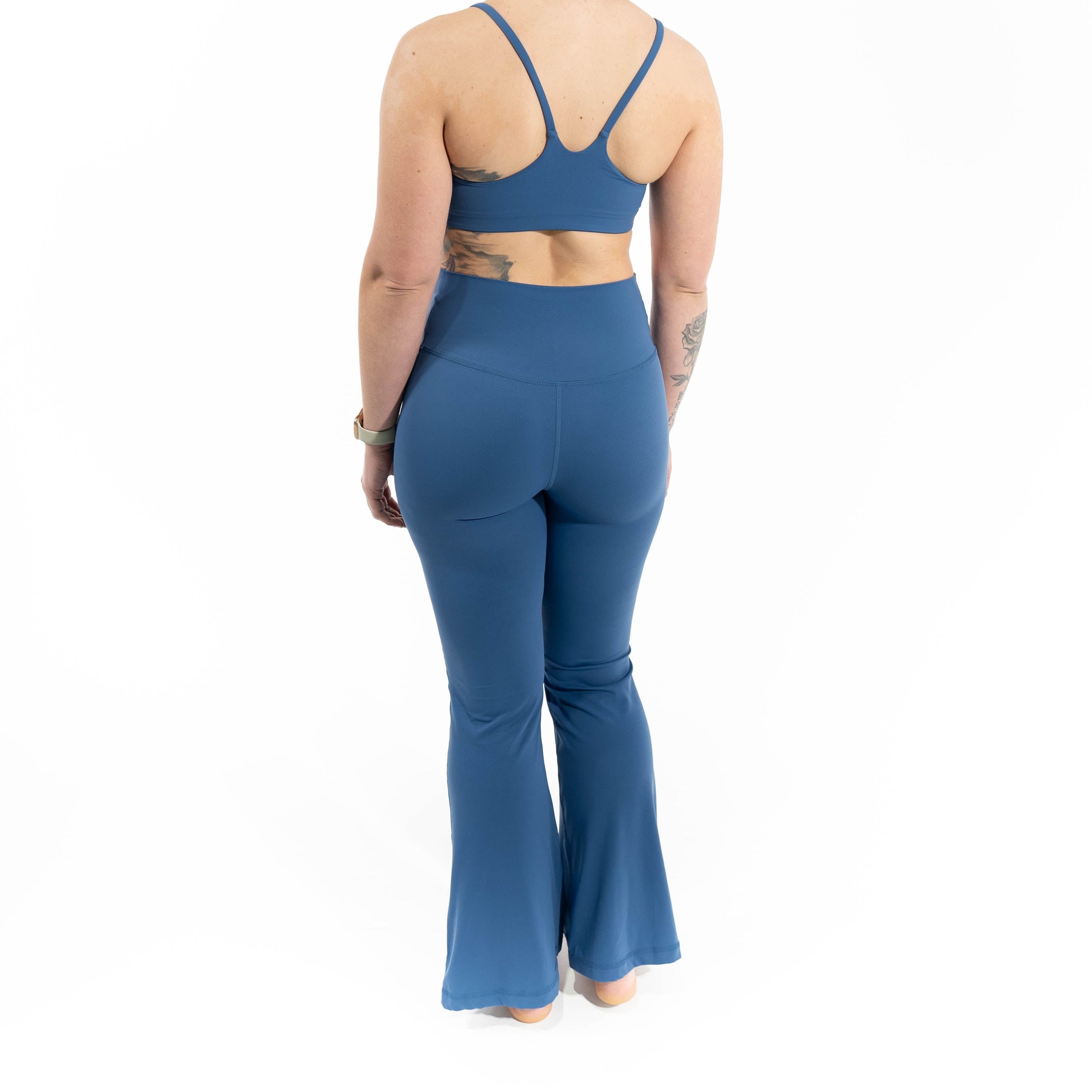 Woman wearing a blue athletic outfit on a white background