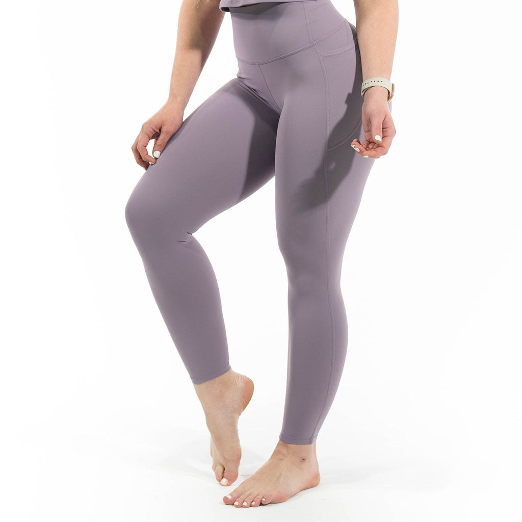 Woman wearing a purple athletic outfit on a white background