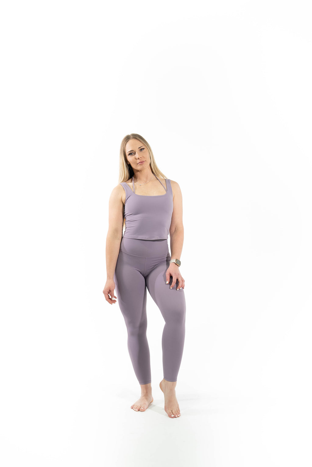 Woman wearing a purple athletic outfit on a white background